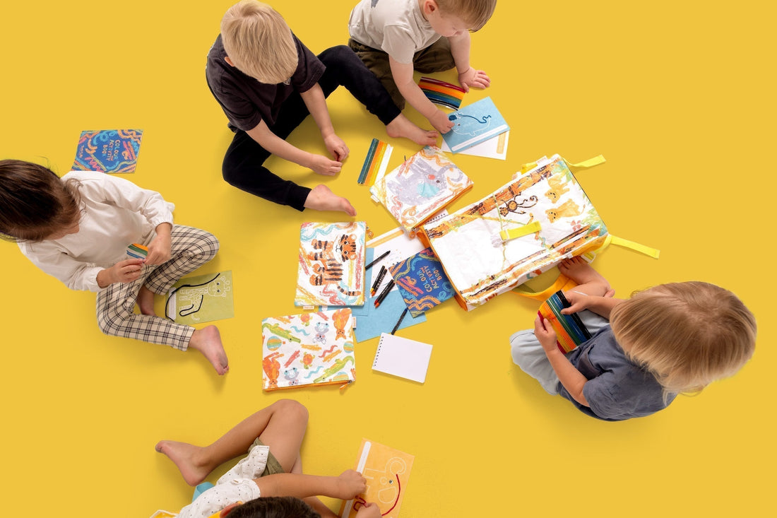 Children sitting in a circle playing with TWO CUBS travel entertainment and engaging activities Crafty Curls and travel activity kit