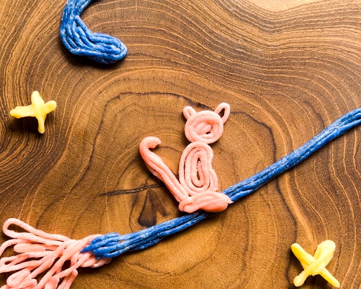 a cat and broom made from Crafty Curls for Halloween activities