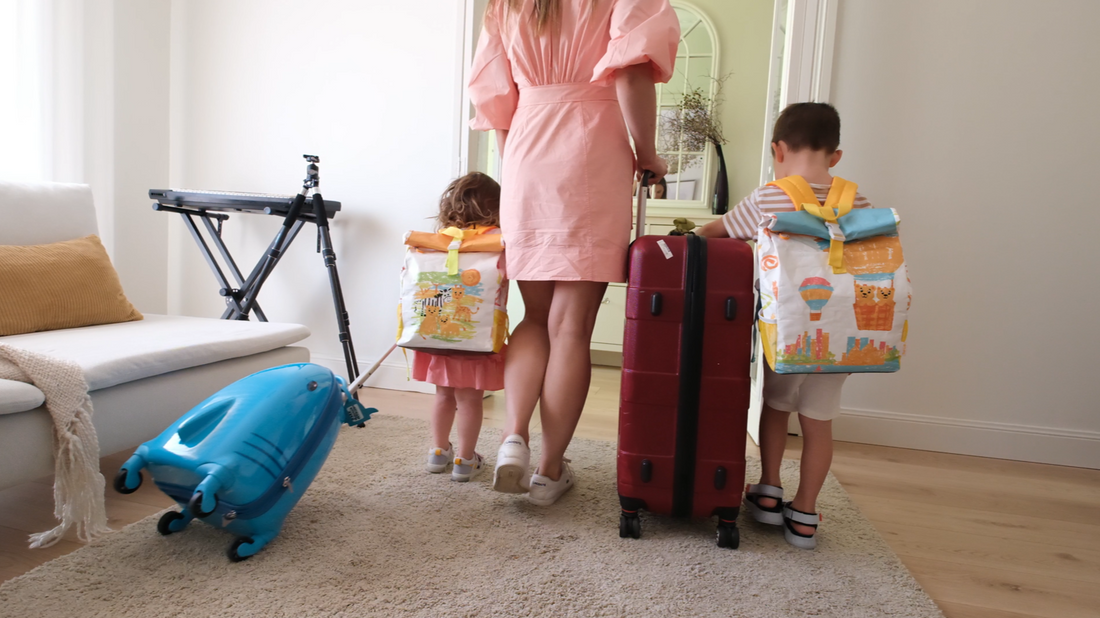 A mother and two children, each with TWO CUBS backpacks ready for a family trip.