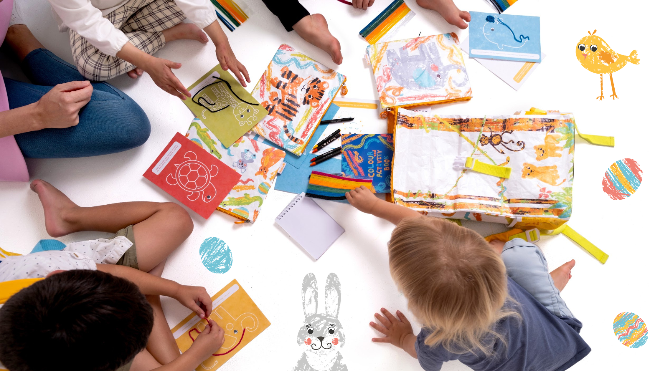 A group of children engaged in creative play with TWO CUBS travel kits and Crafty Curls on a colourful background, surrounded by Easter-themed drawings and crafts, showcasing the joy and engagement of educational activities during travel.