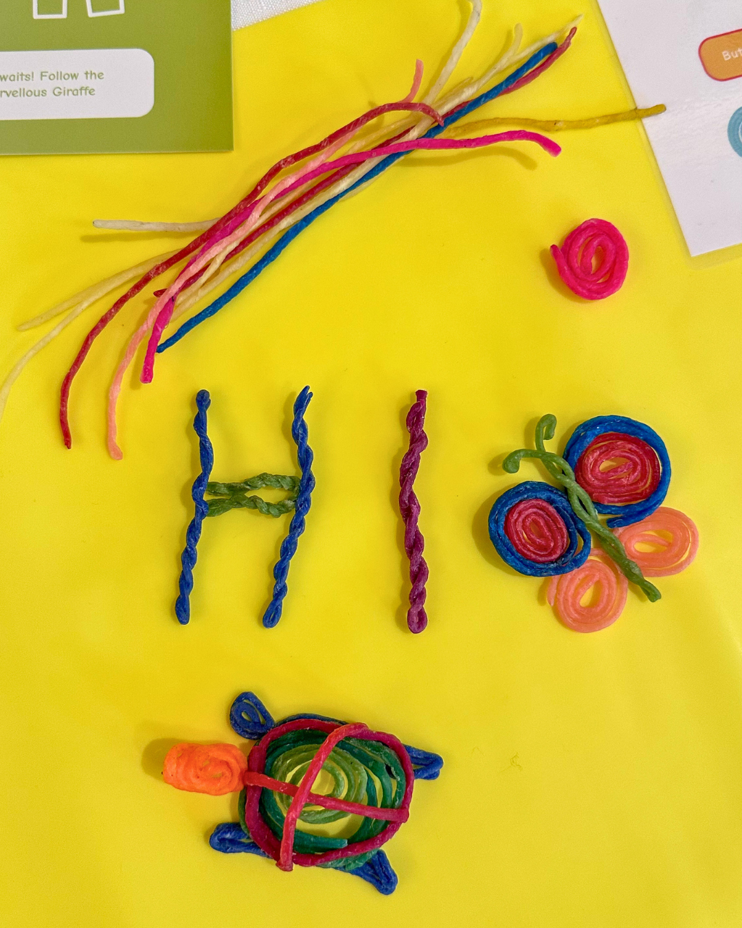 Colourful Twisty Kids reusable wax sticks set out for a screen-free craft activity for kids.